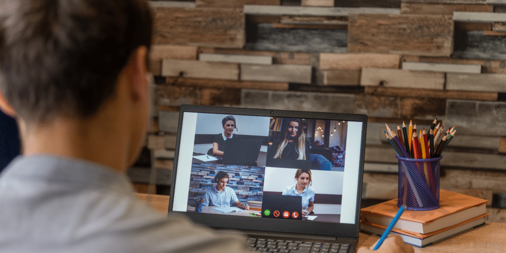 Male behaviour support practitioner in a video conference, with the laptop screen visible, engaging in a professional discussion