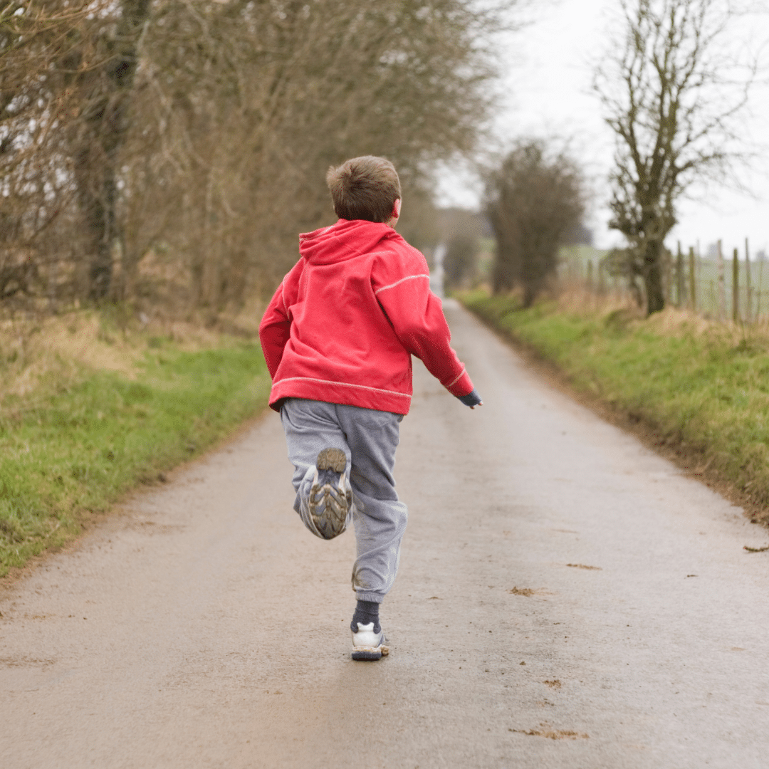 Image of a young child running away from the camera illustratin escape maintained behaviour